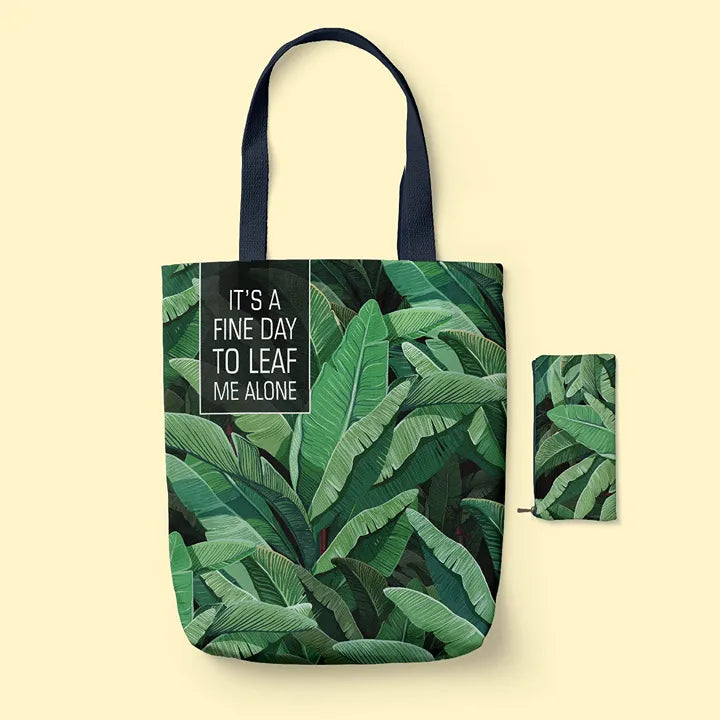 Tote Bag with leaf pattern and 'It's a fine day to leaf me alone' text on a beige background