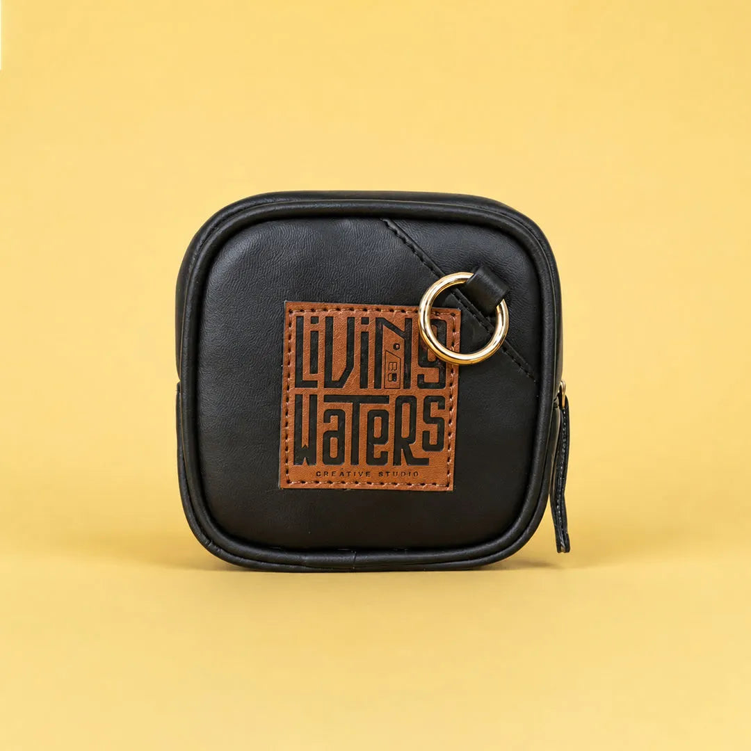 Back view of the illustrated faux leather mini pouch featuring a metal hanging ring for attaching to bags and keychains.