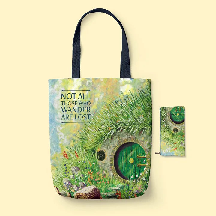 Tote bag with hobbit door design and 'Not All Those Who Wander Are Lost' quote on a beige background